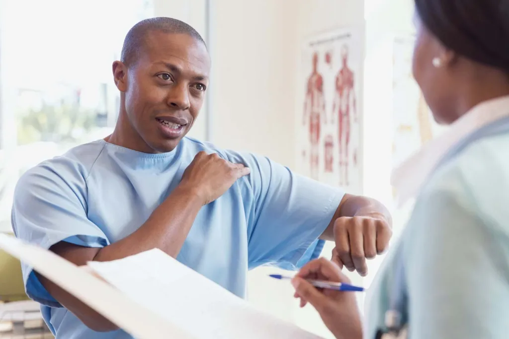Adult patient speaking with a healthcare professional during a primary care visit